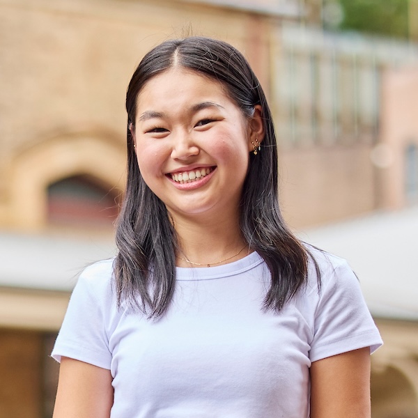 Notre Dame student wearing white top in Sydney campus courtyard