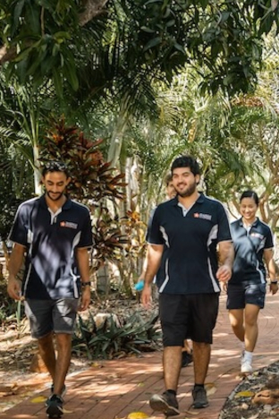 Students walking in the bush on Broome campus in Notre Dame clothing