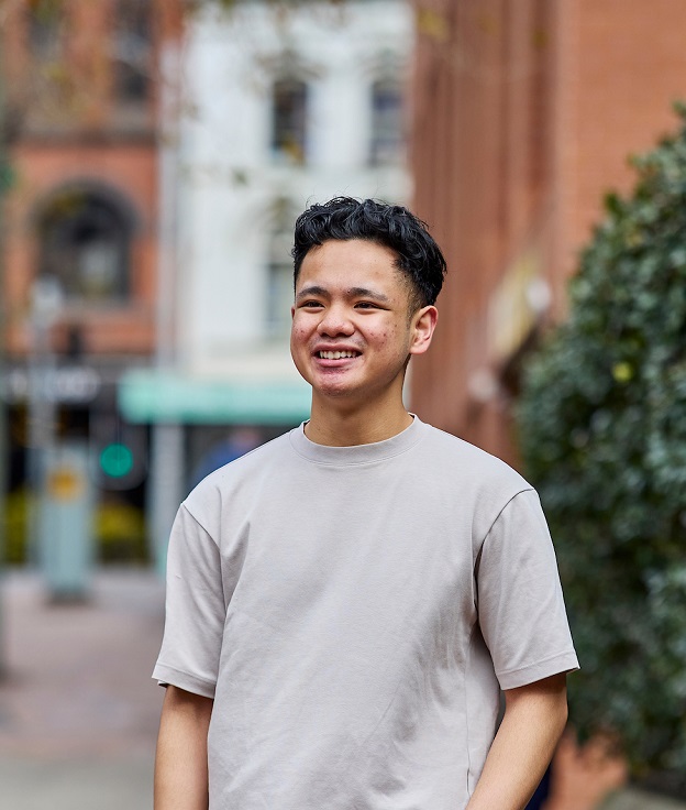 Nursing student Carl standing outside on Broadway Campus