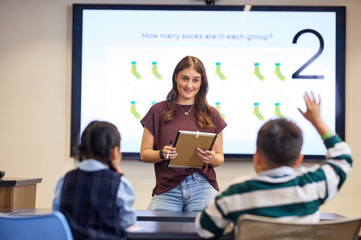Female undergraduate teaching in a classroom