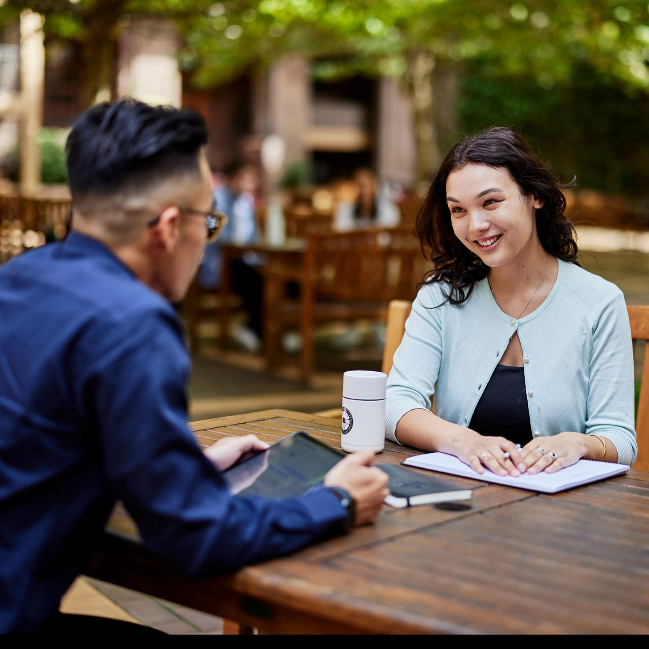 Male and female undergraduate students sitting in the courtyard of the Sydney campus 