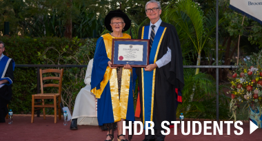 Link to HDR Students over a student being handed her degree at a Broome graduation ceremony.