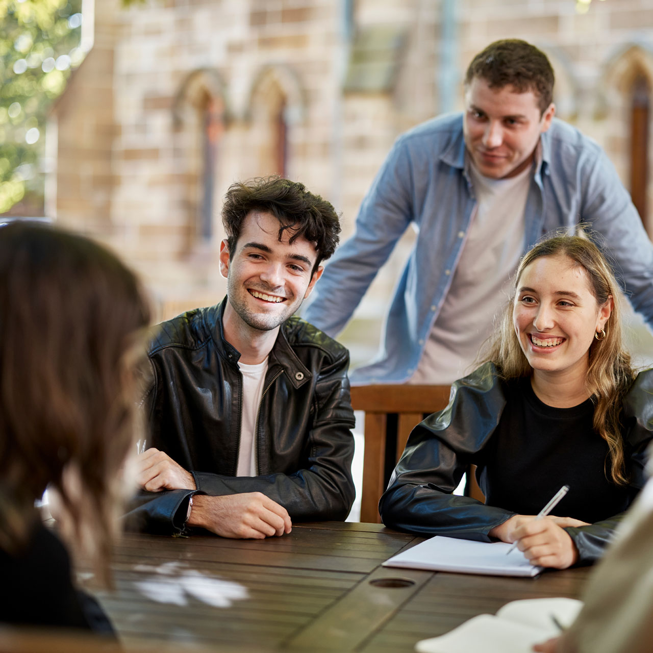 Group of undergraduate Notre Dame students sitting in the courtyard of the Sydney campus 