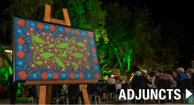 Link to adjuncts over Aboriginal artwork on stage.