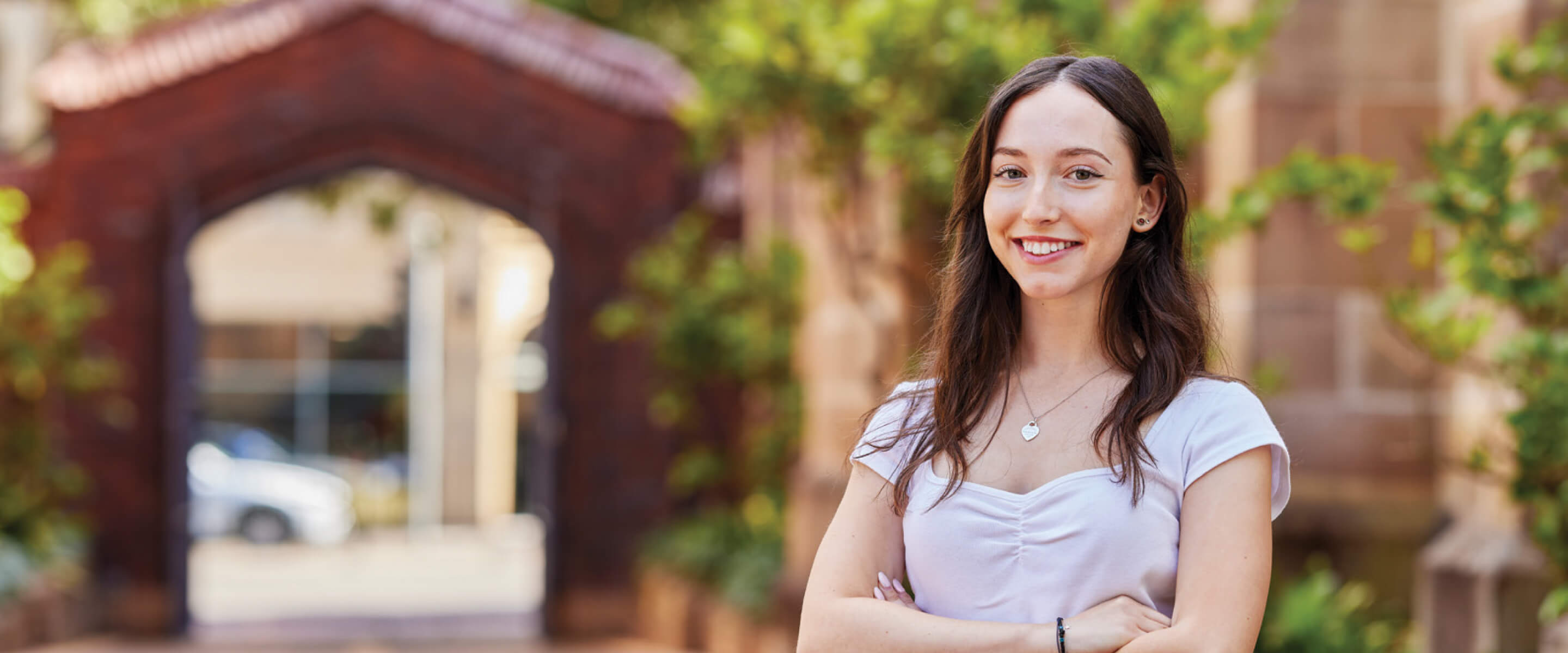 Notre Dame female undergraduate Education student Sophie wearing a white top standing inside the Sydney campus 