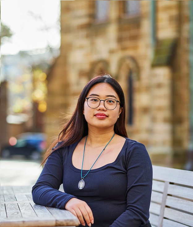 Sydney student sitting in the courtyard on the Broadway Campus